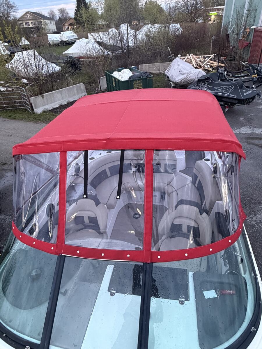 Red custom canvas enclosure on a powerboat