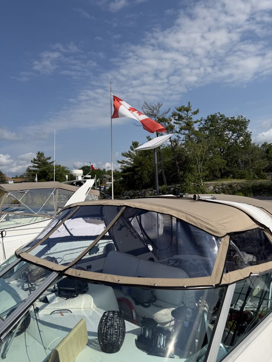 Tan custom bimini and windshield canvas on a boat